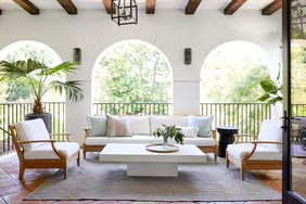 Veranda with archway door, couches, and chairs