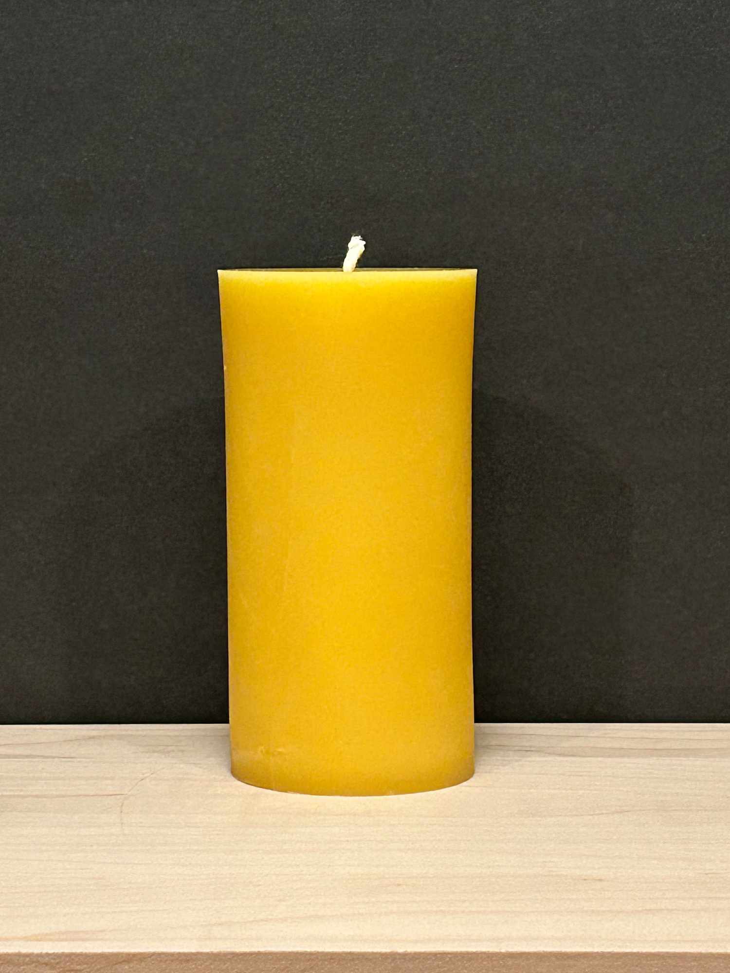 A yellow beeswax candle