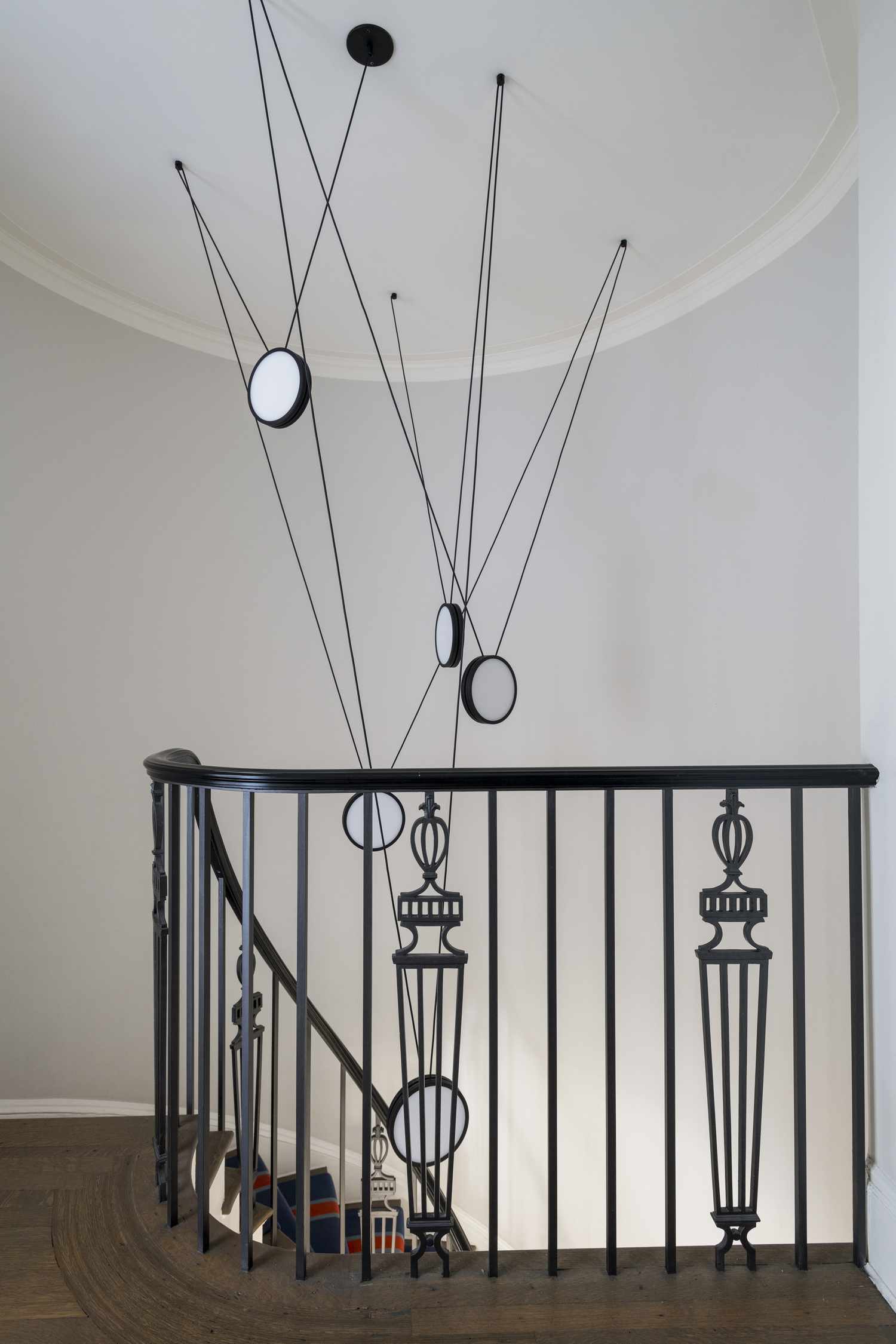 decorative metal staircase railing with modern light fixture