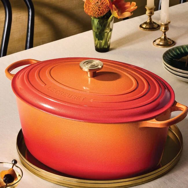 Signature Oval Dutch Oven with Crucible Knob in Flamme Dorée from Le Creuset. 