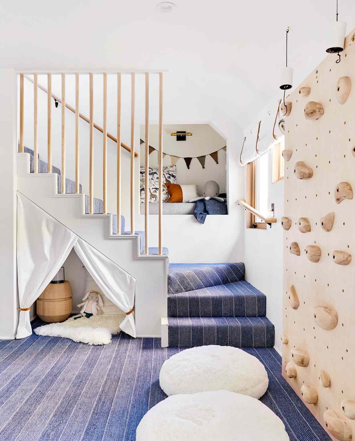 plush basement stairs with nooks for children and a climbing wall