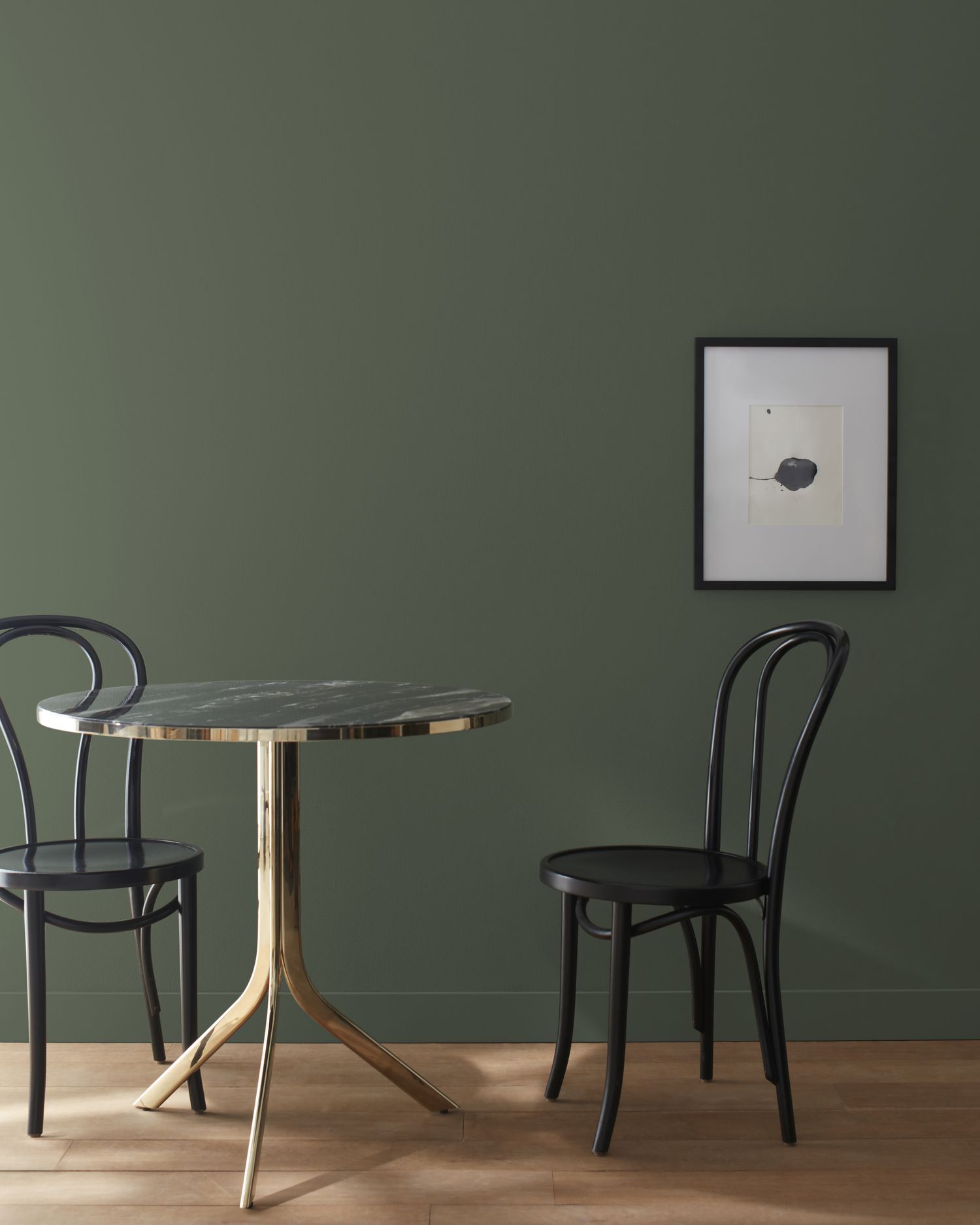 dark green wall with table and chairs