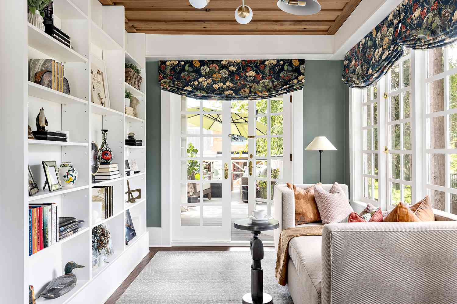 white shelves in sunroom with french doors and daybed