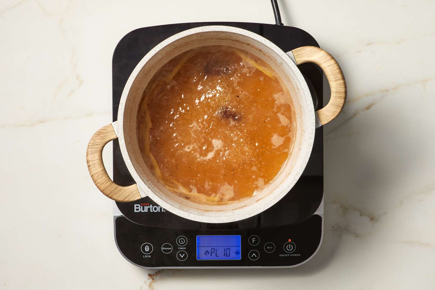 overhead view of poaching liquid on burner