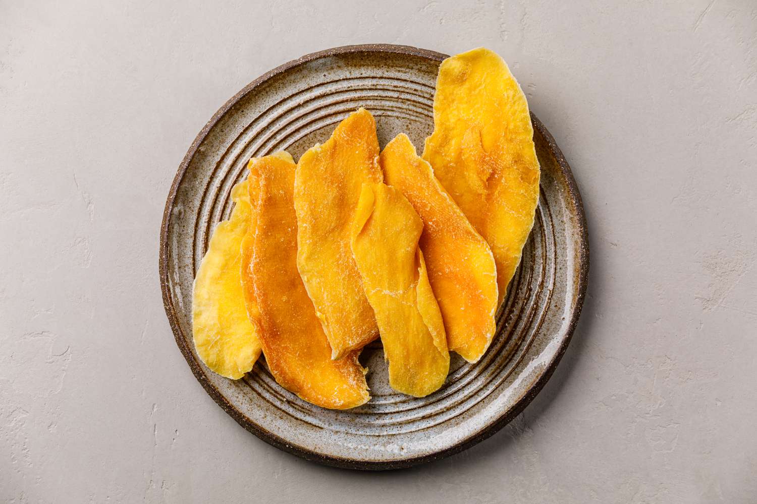 dried mango on handmade plate