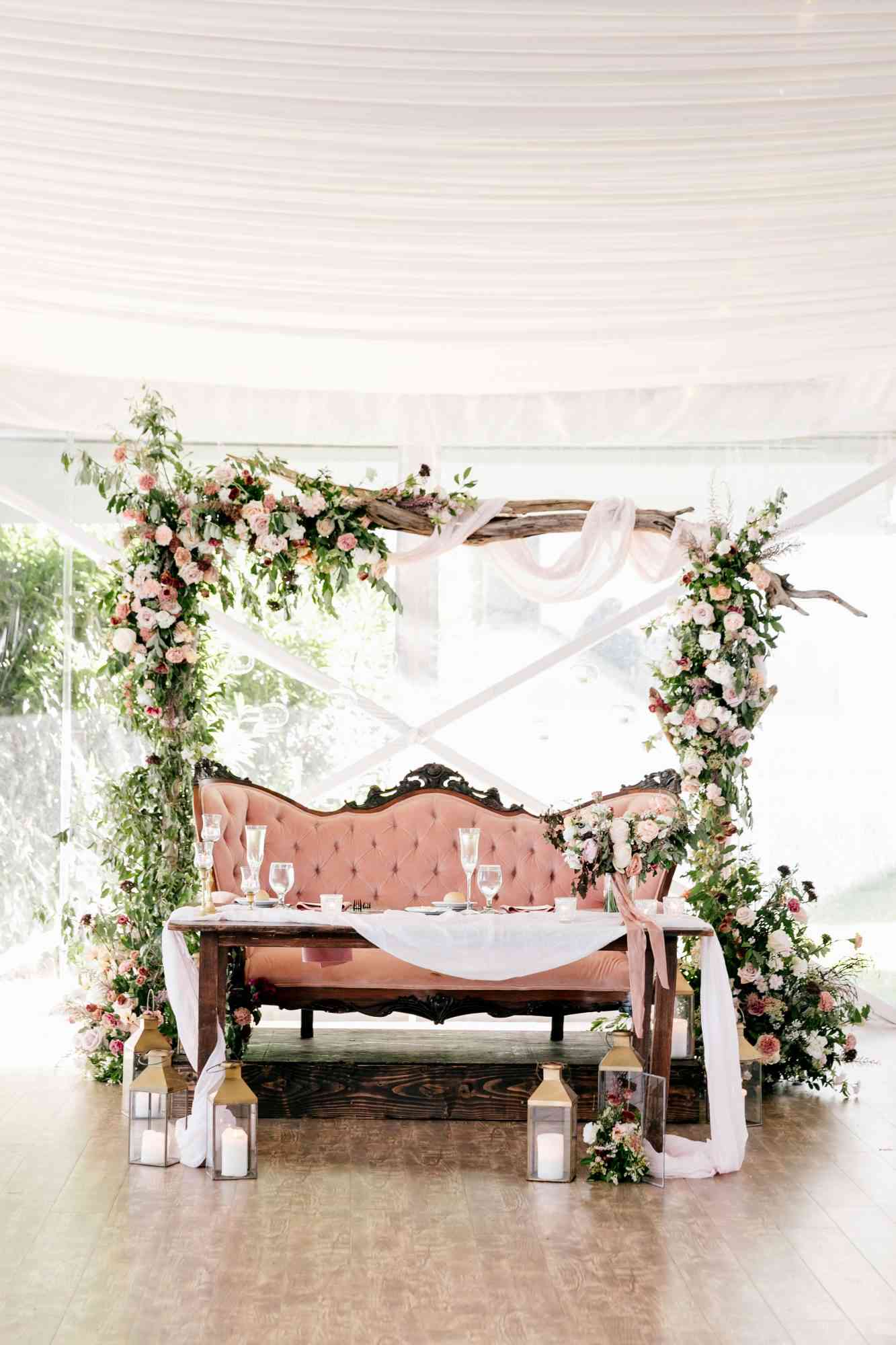 sweetheart table floral arch pink love seat