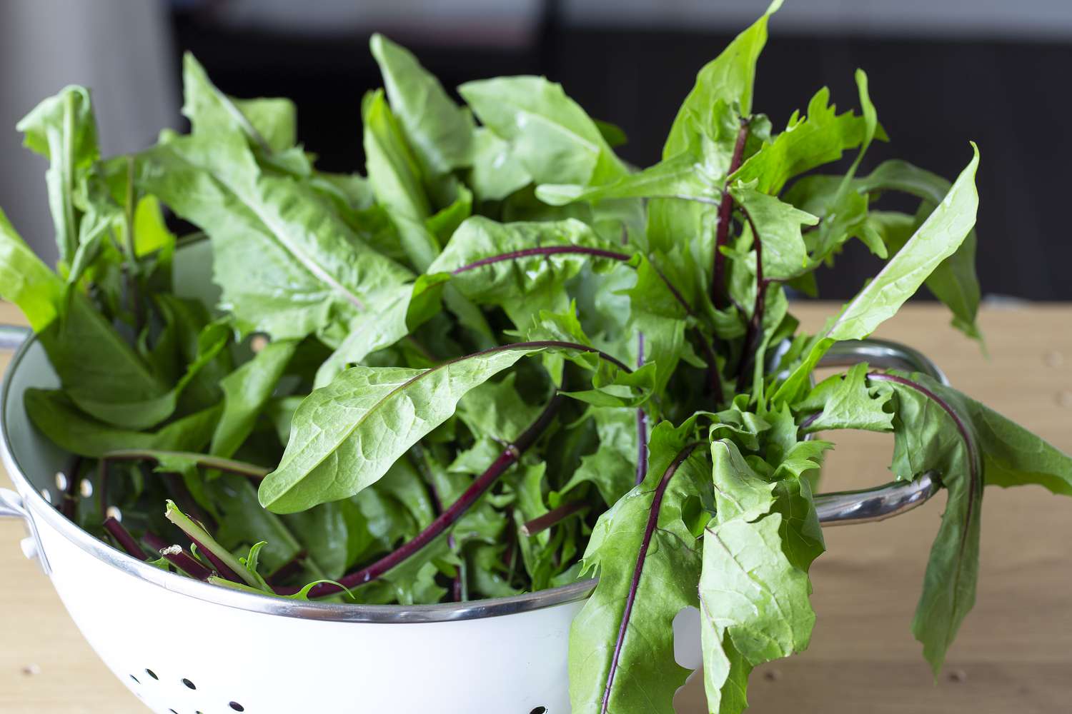 dandelion greens in white colander