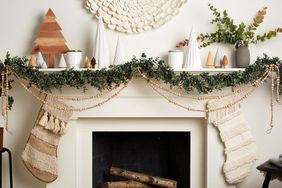 Scandinavian-inspired mantle white with wooden beaded garland greenery and trees