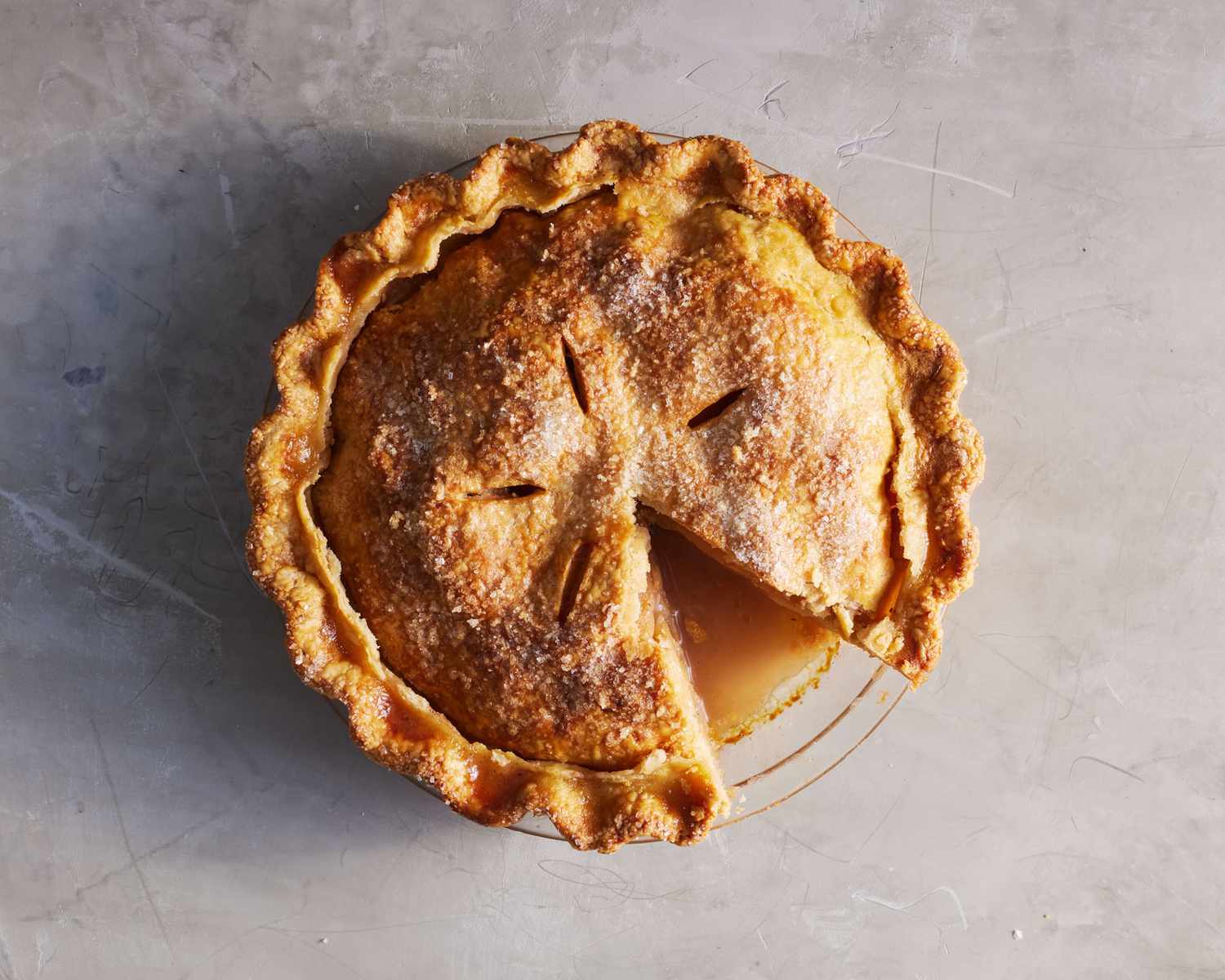 best apple pie recipe with slice cut out on grey countertop