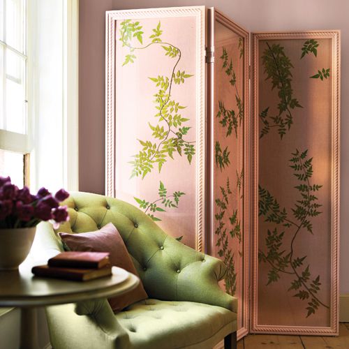 A pink room divider with green pressed leaves.