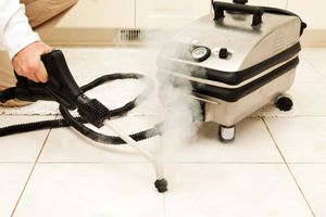 Steam cleaning a tile floor using a portable steam cleaner