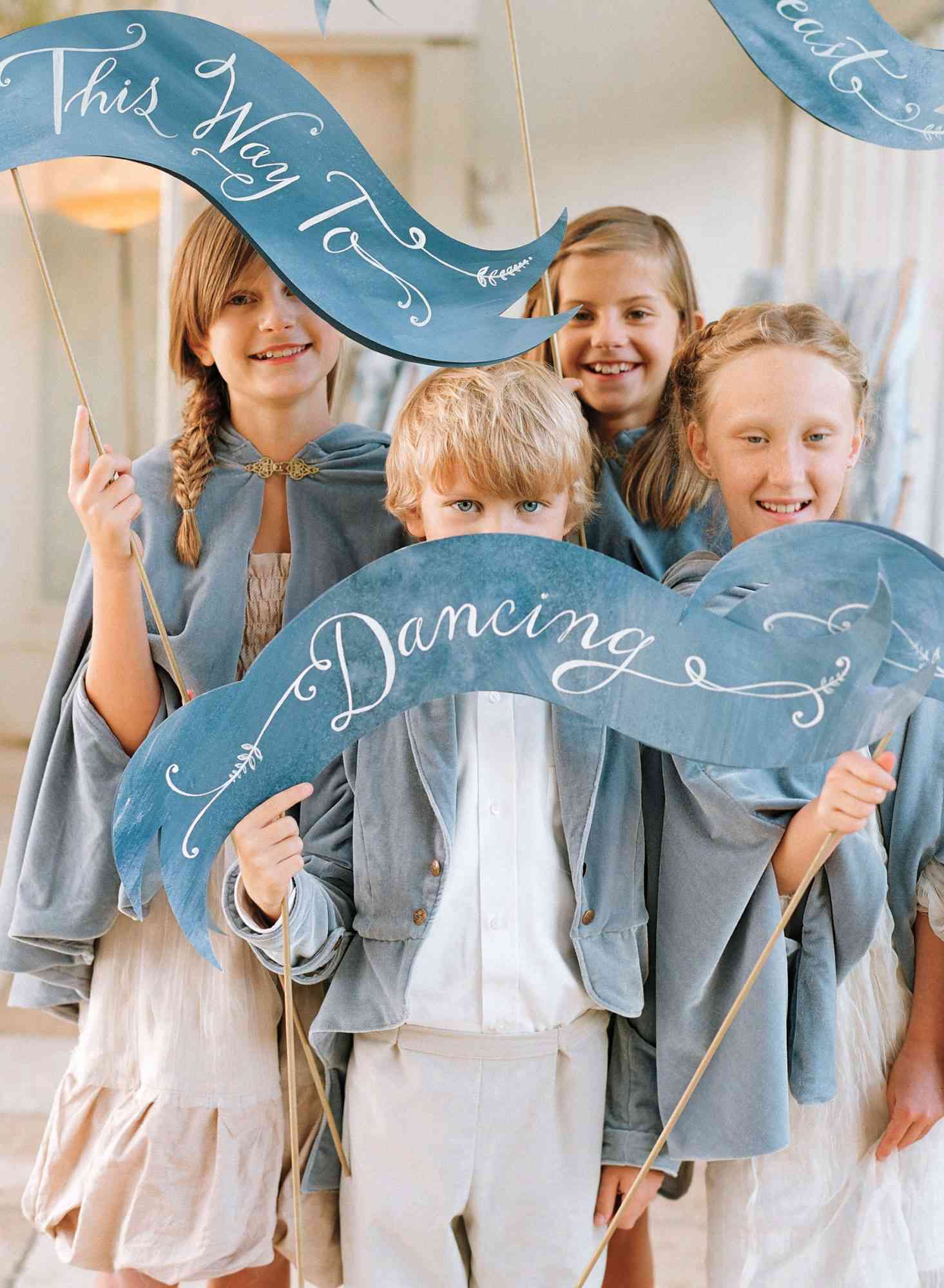 kids with wedding signs