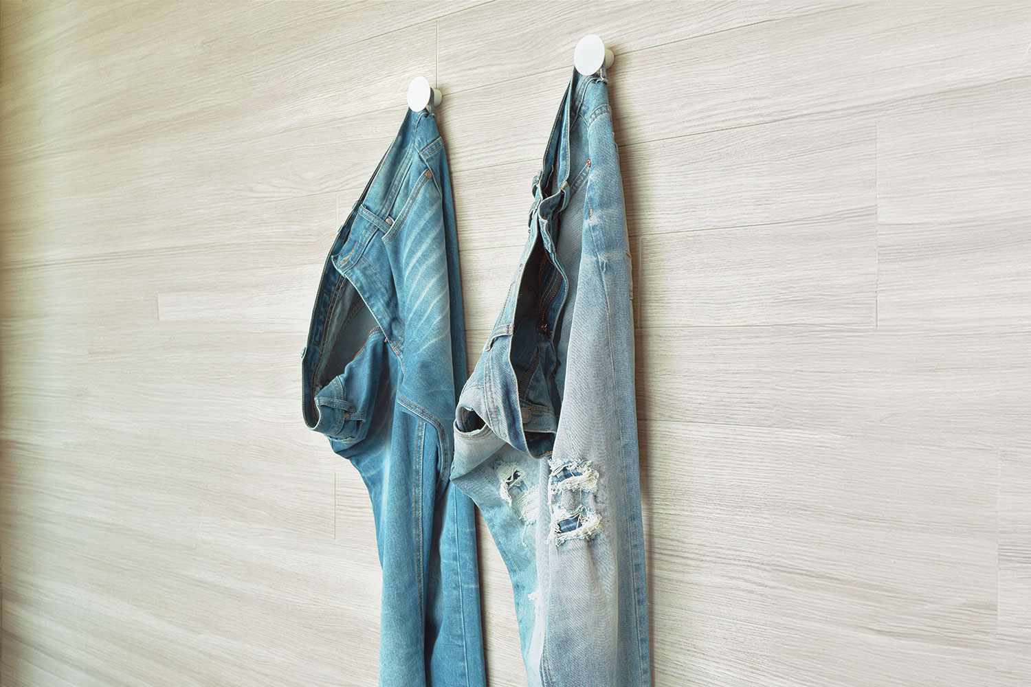 Jeans hanging on hooks