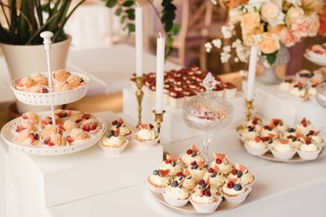 Dessert display with cupcakes tartlets and pastries on a table