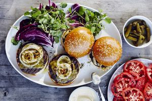 bistro burgers with grilled onions and cheese on white platter