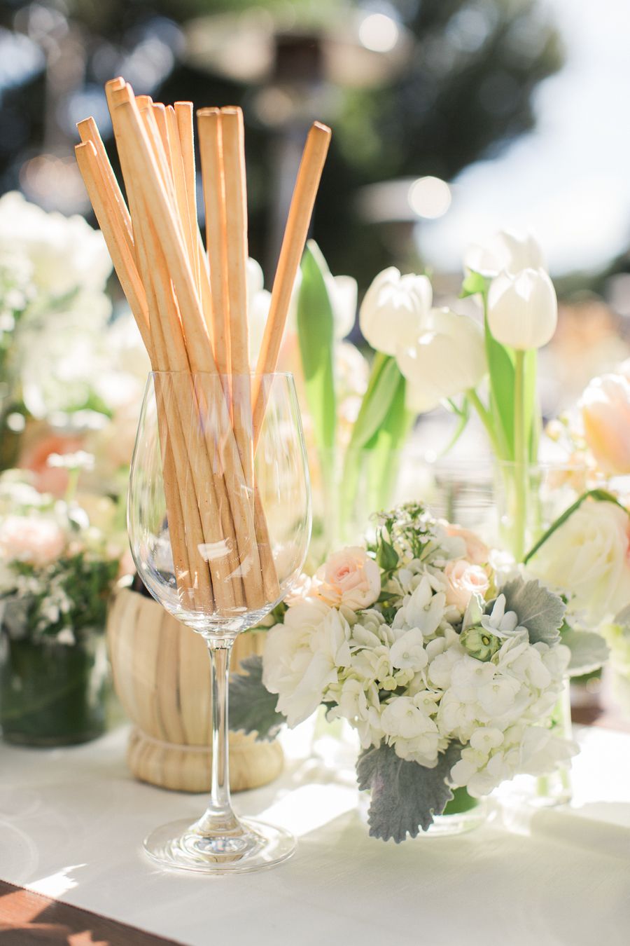 bread sticks in wine glass on table