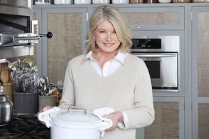 decorvow holding a pot in a kitchen