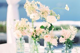 pink roses and white flowers in glass vases