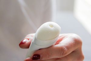 Closeup of a hand holding a deodorant stick opened