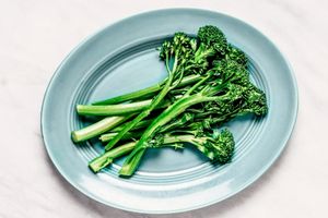 steam broccolini on blue blate