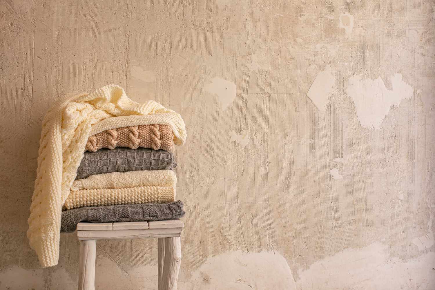 pile of wool blankets on a wooden table