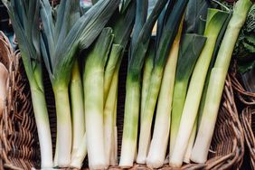 Basket of organic leeks selling in vegetable market. Vegan food and lifestyles. Small business. Economy and inflation.