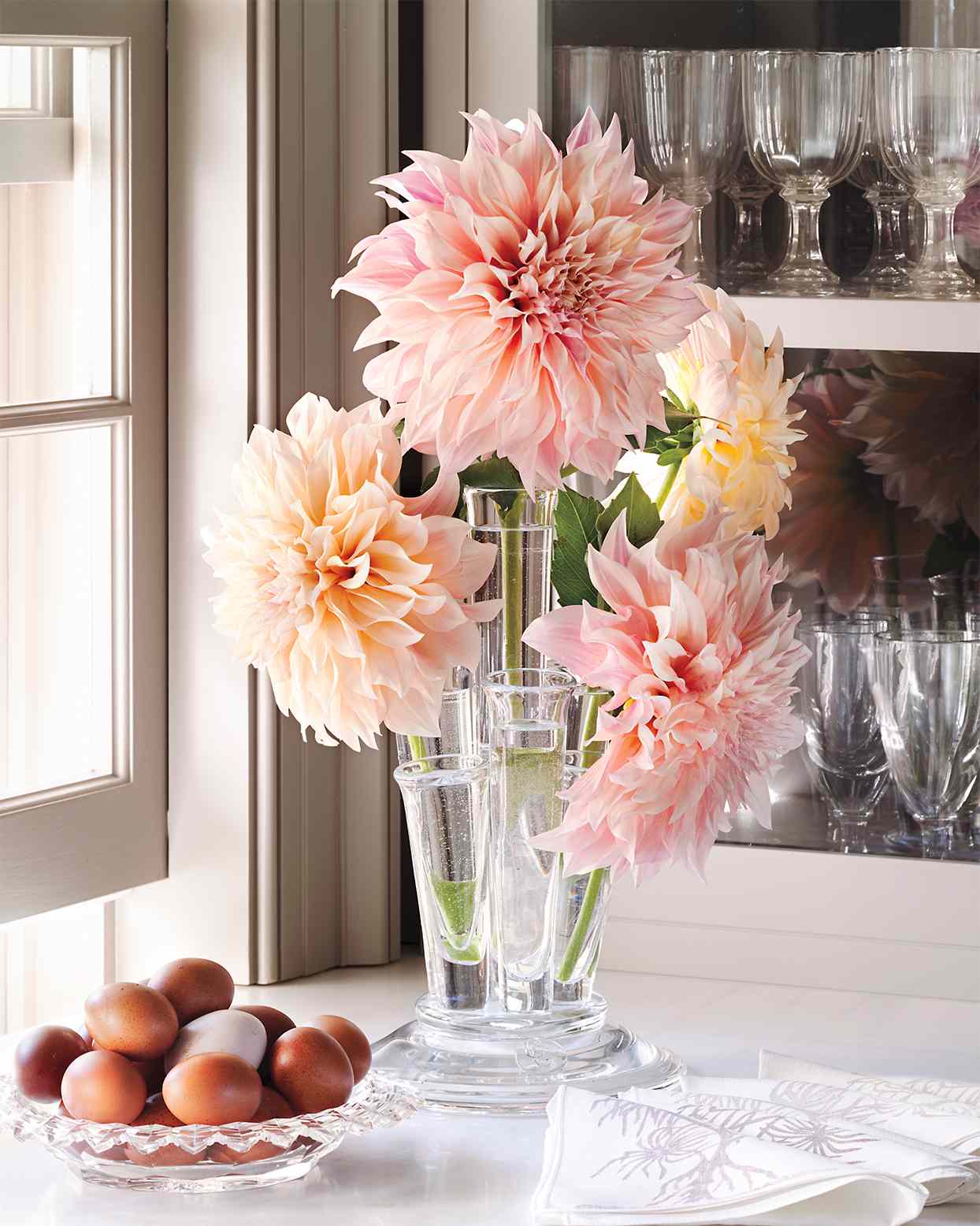 pink dahlias arranged in clear vases