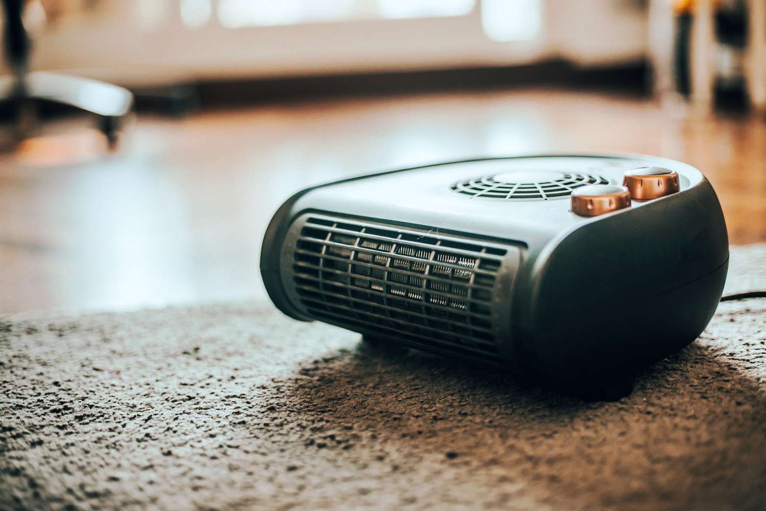 Portable space heater on a carpeted floor in a home setting