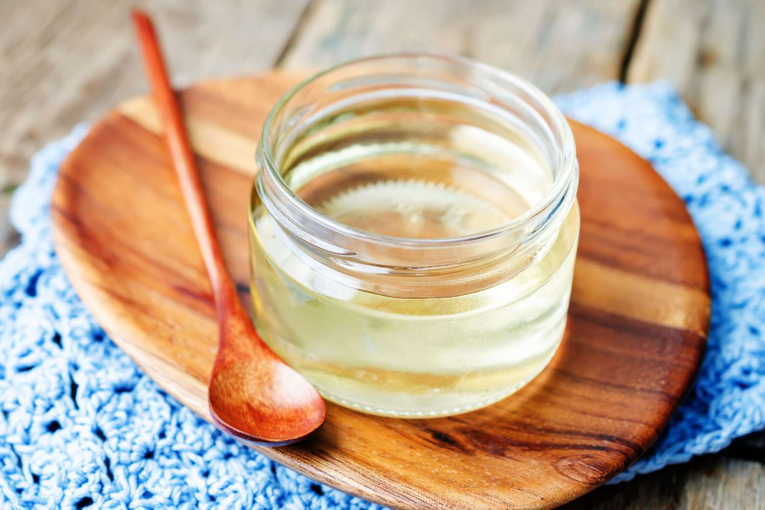 Corn syrup in glass jar on a wooden board
