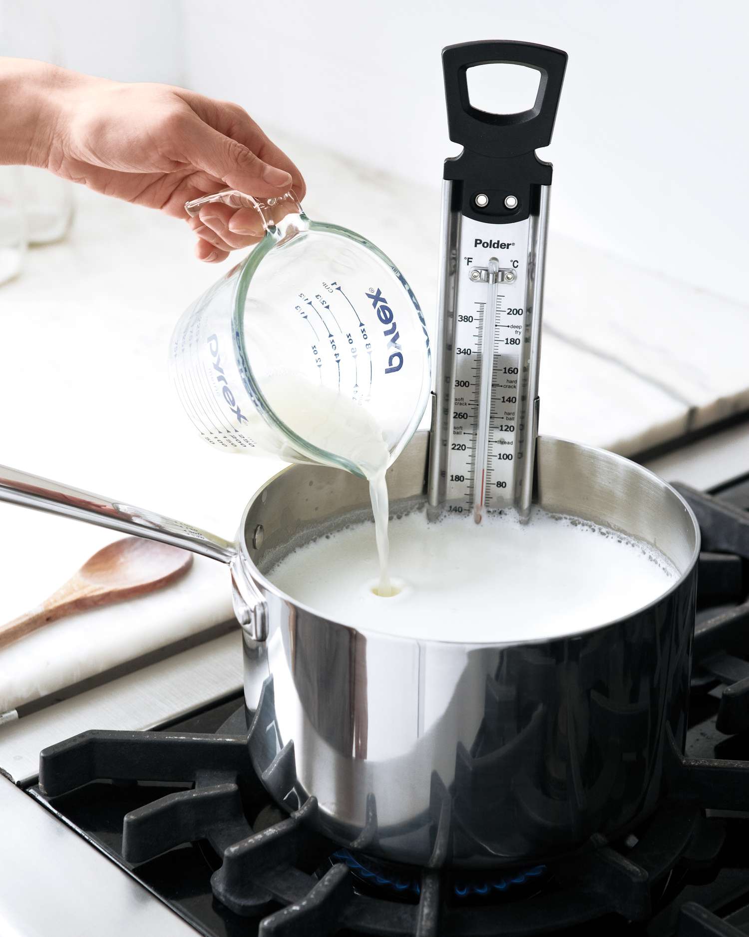 adding lemon juice to milk and cream for homemade ricotta
