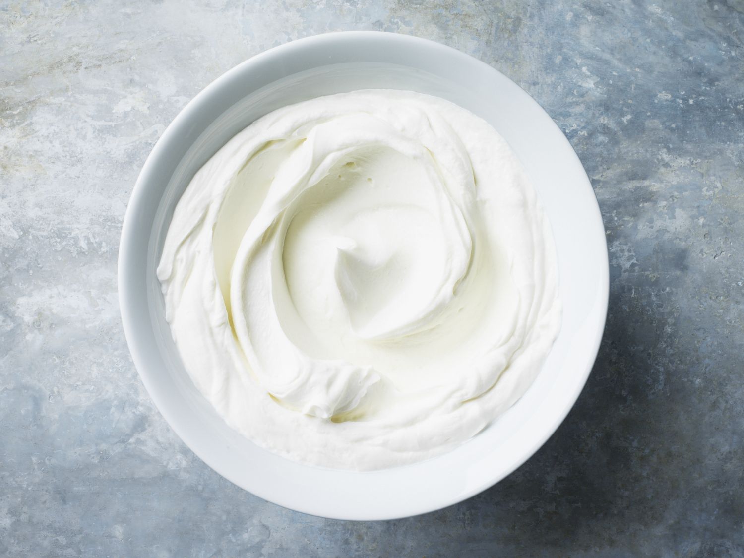 blue and gray background with a bowl of sour cream