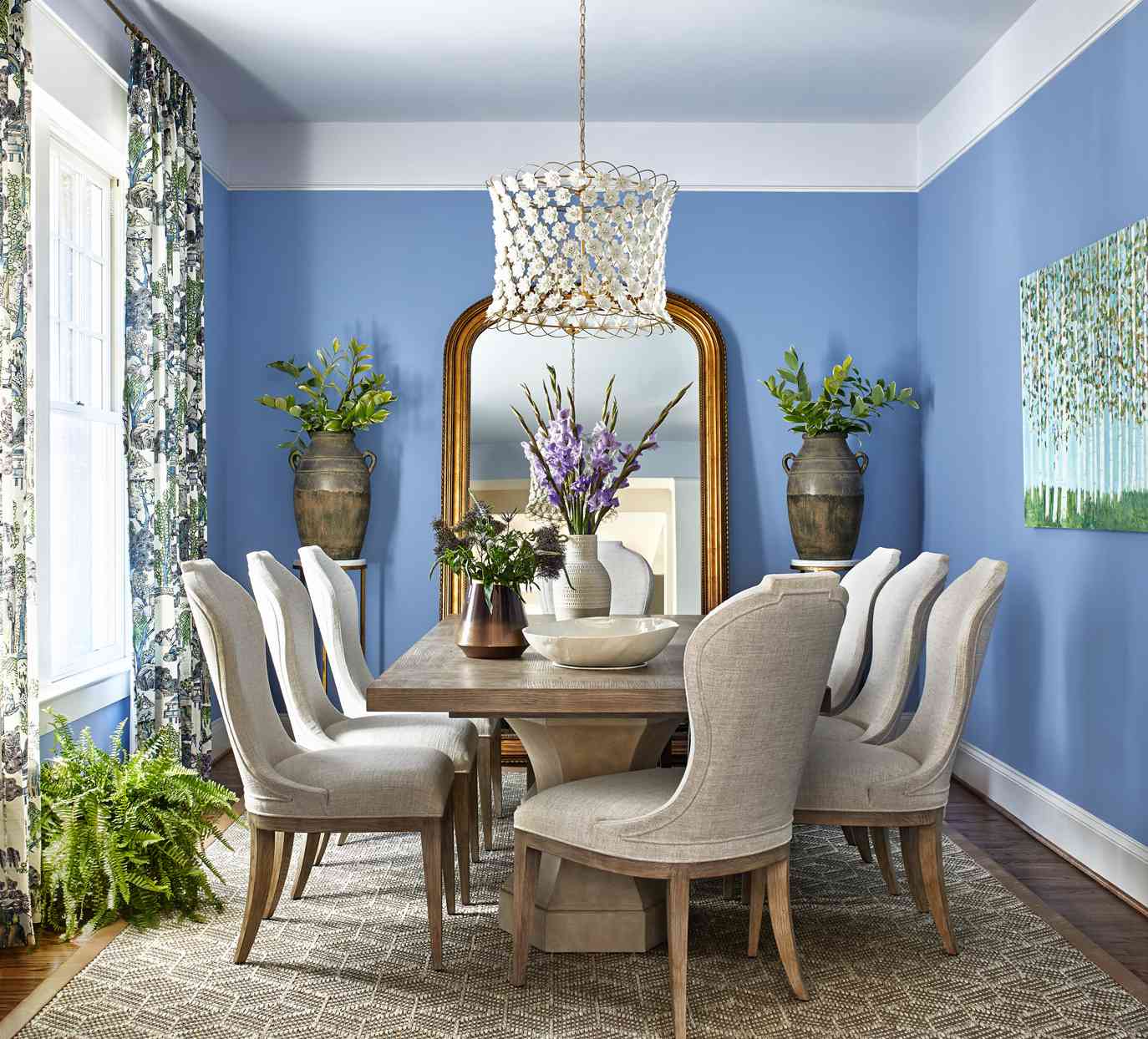 lavender-blue dining room decorated with greenery