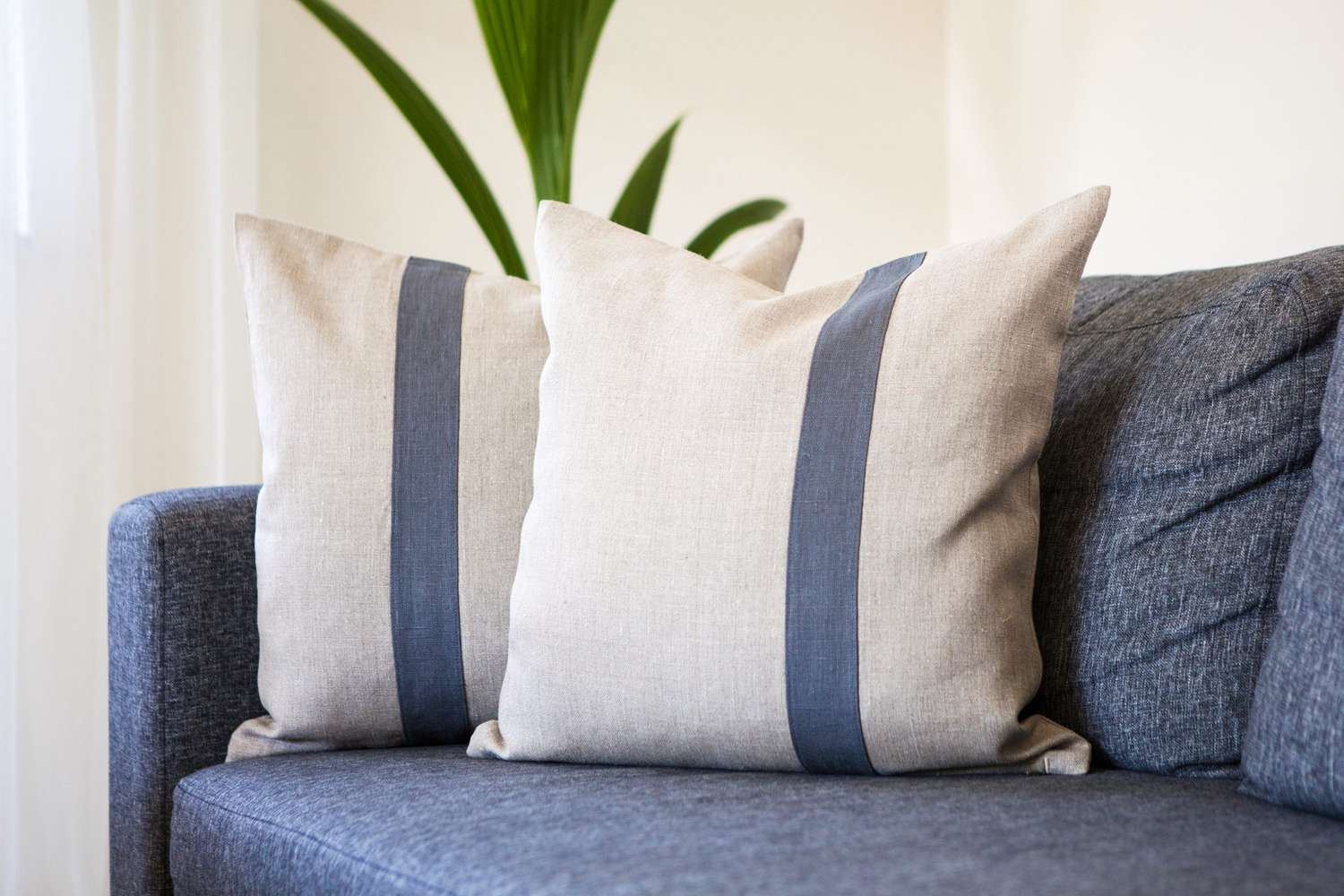 upholstered sofa with cream pillows