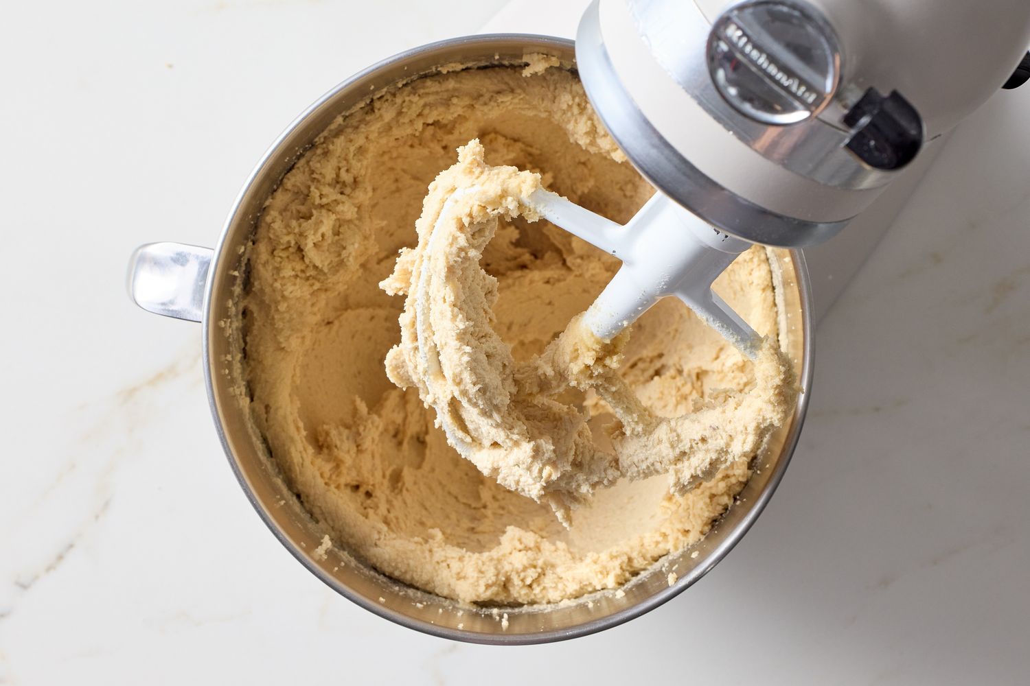 Stand mixer bowl with cookie dough and paddle attachment