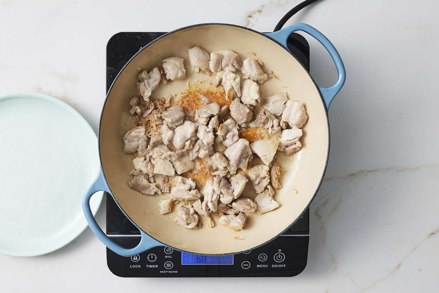 Chicken cooking in skillet
