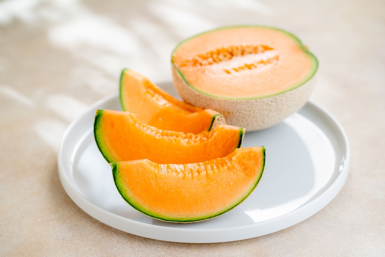 Slices of cantaloupe melon on a white plate