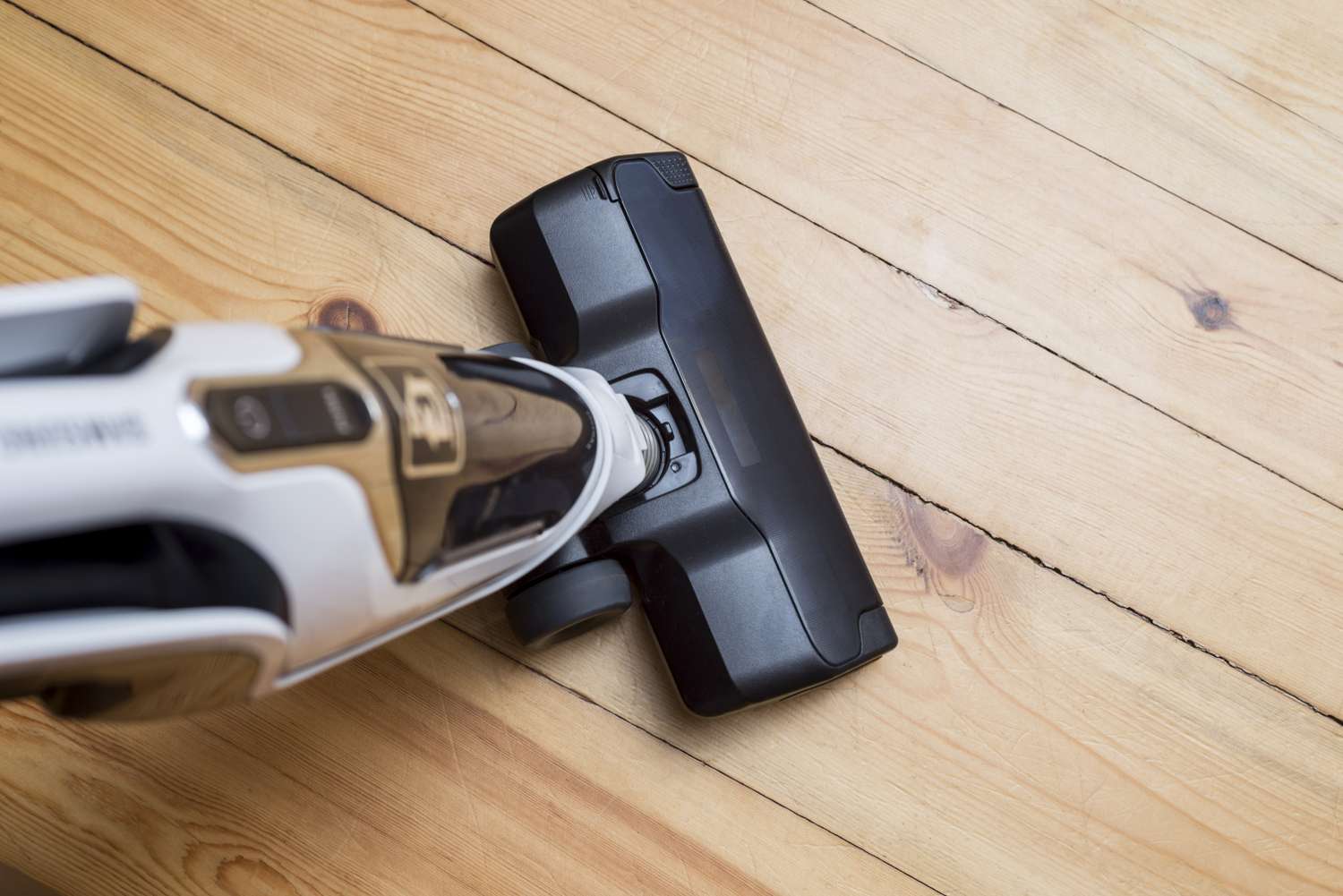 A closeup view of a vacuum cleaner on a wooden floor