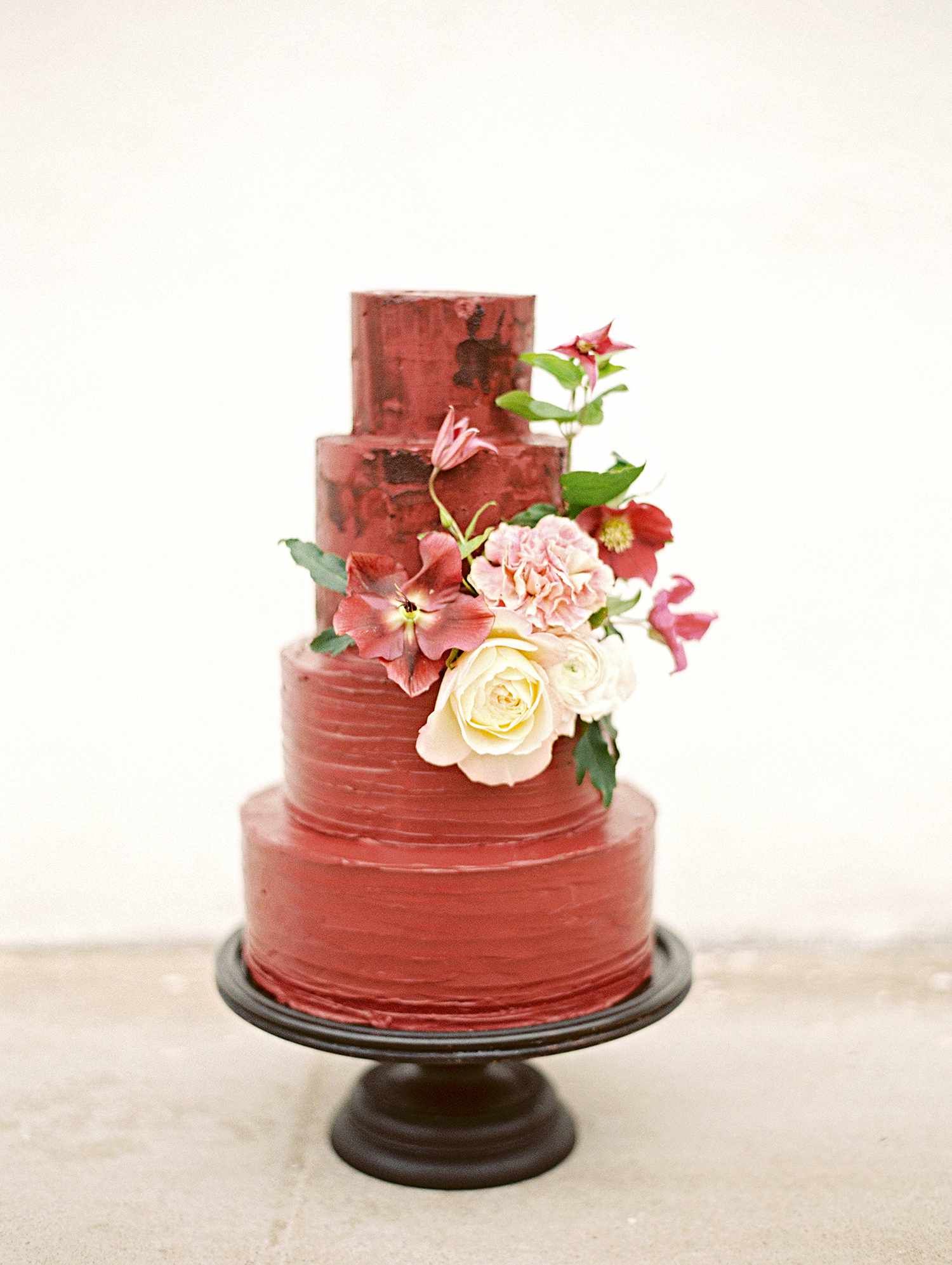 red velvet tiered cake with blooms