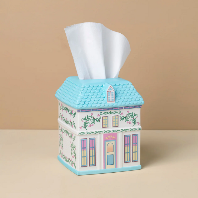 A tissue box holder designed to resemble a decorative house with architectural details