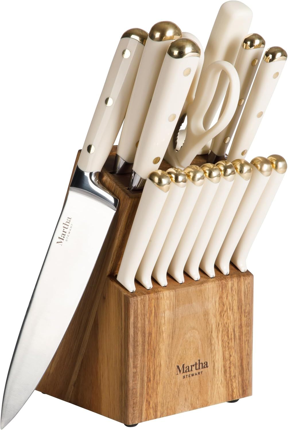 A set of kitchen knives with white handles presented in a wooden block labeled decorvow