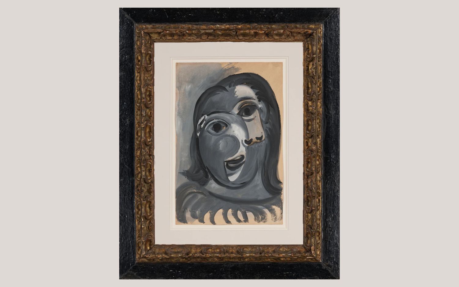 Painting showing abstract face framed in a decorated wood border