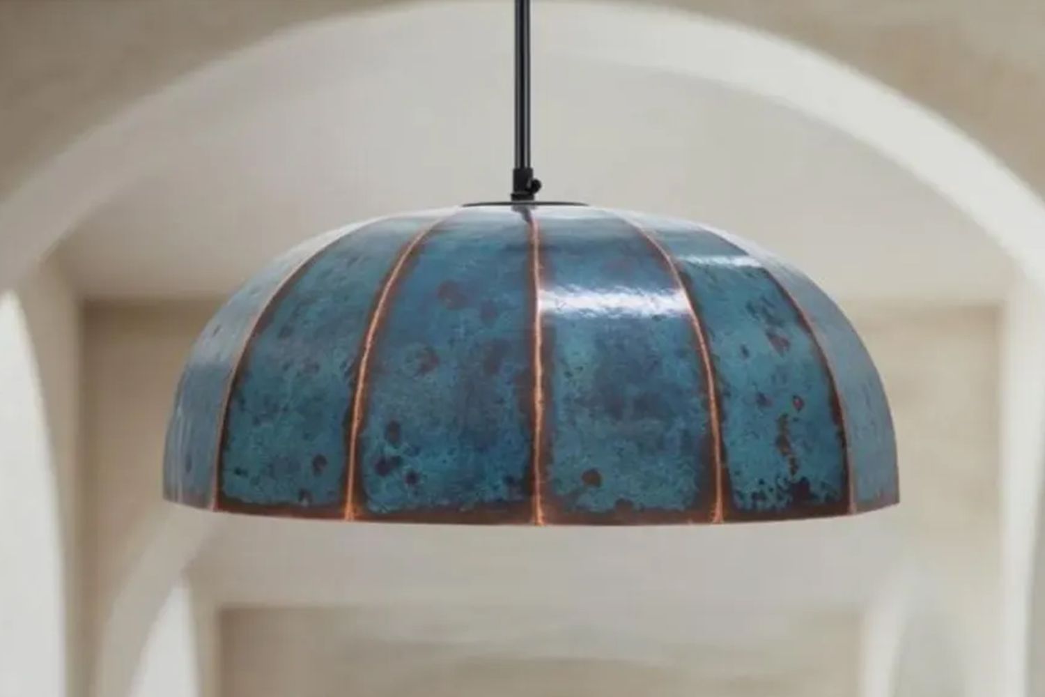 Pendant lamp with a domeshaped metal shade featuring a textured pattern