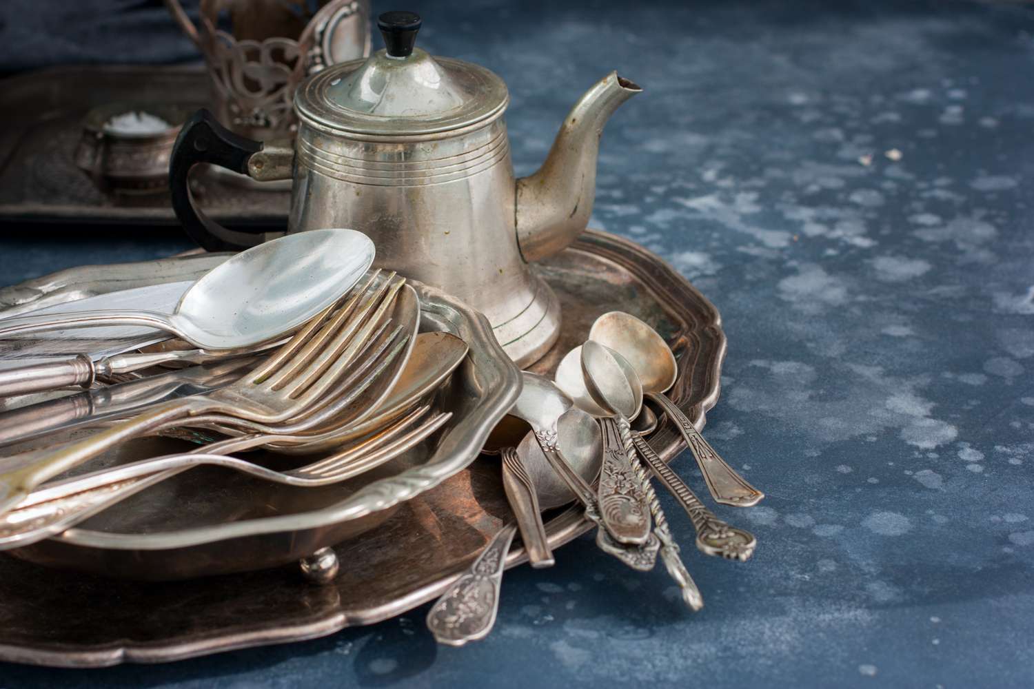 A set of vintage tableware and a teapot displayed on a tray