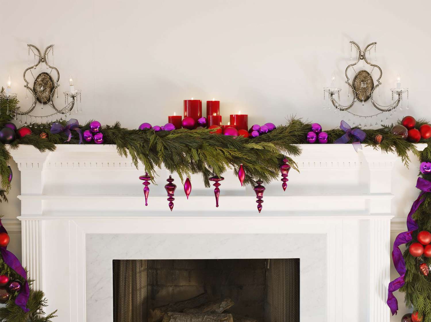 Decorated mantel with greenery ornaments and candles
