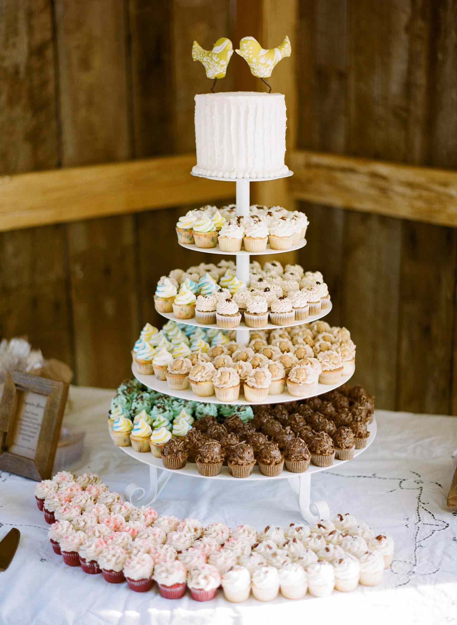 four tiered cupcake stand with multi-colored cupcakes