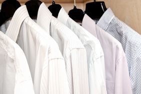 A row of neatly hung collared shirts on hangers