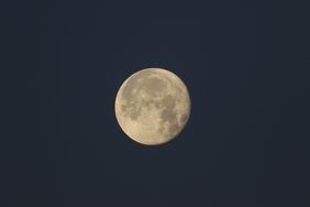 A full Buck Moon in a dark night sky