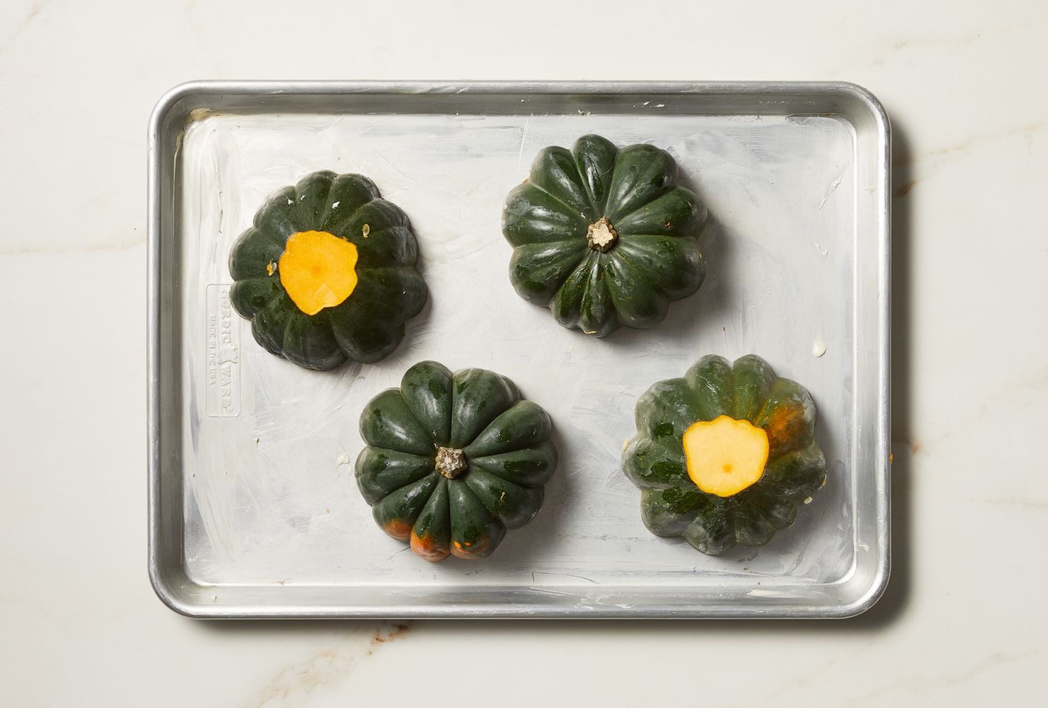 overhead view of acorn squash on a sheet pan
