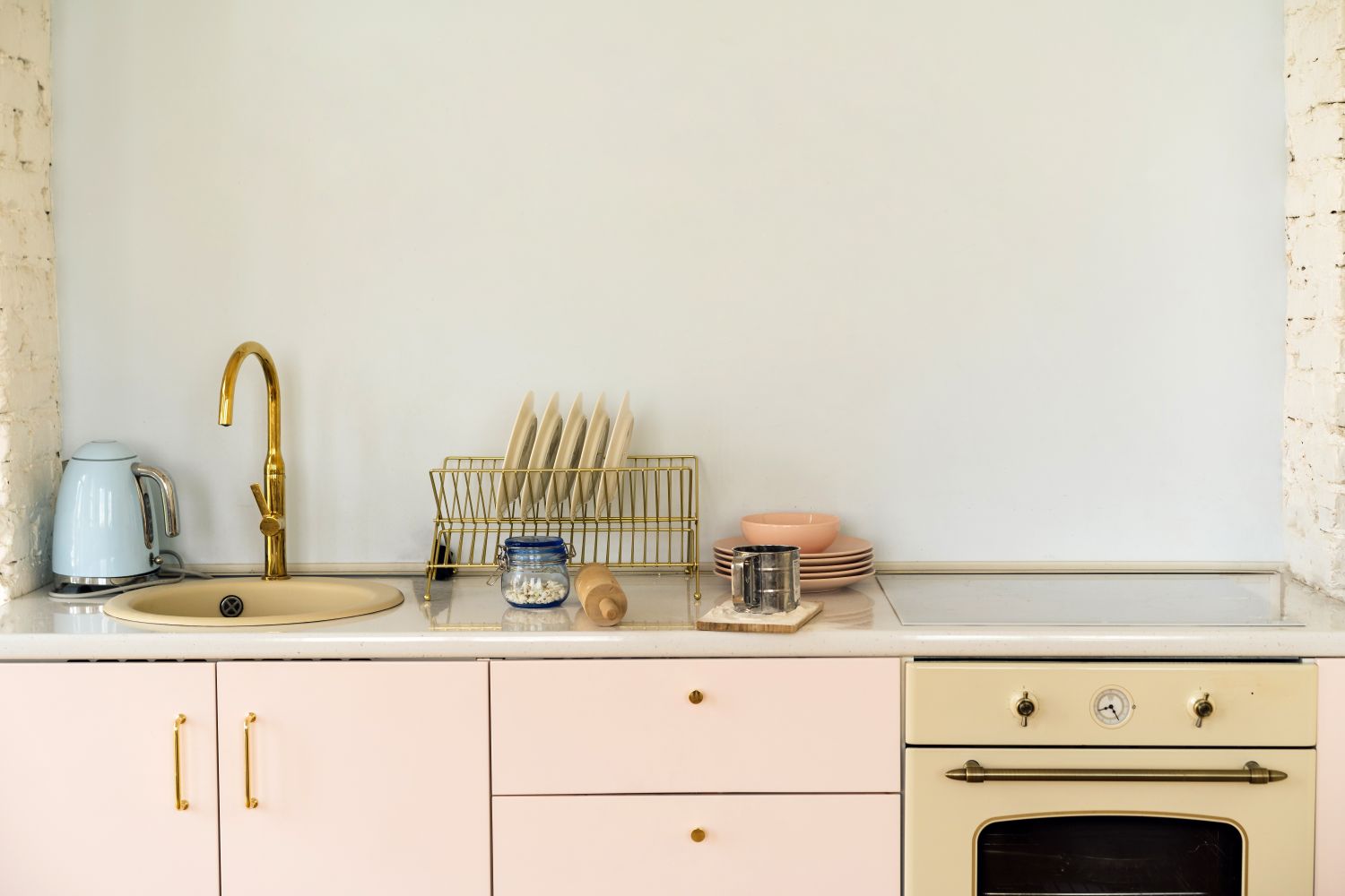 Minimalist kitchen counter with sink faucet drying rack and oven