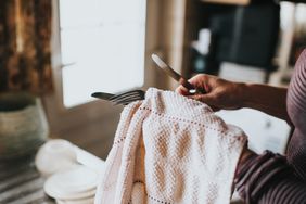 woman dryer silverware with towel